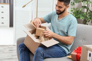 man opening Parcel   blue top